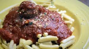 cavatelli and meatballs on yellow plate