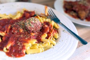 cavatelli and meatballs on glass plate